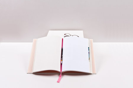 Open book on white table with white background. Back to school concept.の写真素材