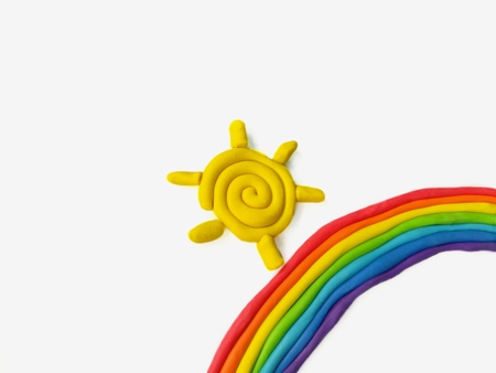 Colorful plasticine clay made are beautiful rainbow and yellow sun on white background,cute nature doughの写真素材