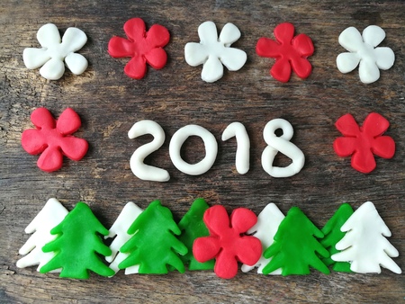 Beautiful year 2018 are colorful clay plasticine put in the middle, Christmas green tree on line...