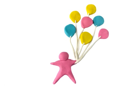 Person hold colorful balloons made from plasticine clay on white backgroundの写真素材