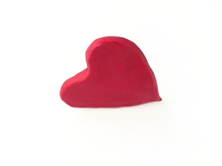 Red heart made from plasticine clay on white background,Valentine doughの写真素材