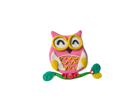 The cute owl is on a branch made from plasticine clay on white background,lovely animal doughの写真素材