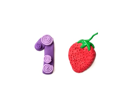Cute number 1 and delicious strawberry made from plasticine, count one math clay dough on white backgroundの写真素材