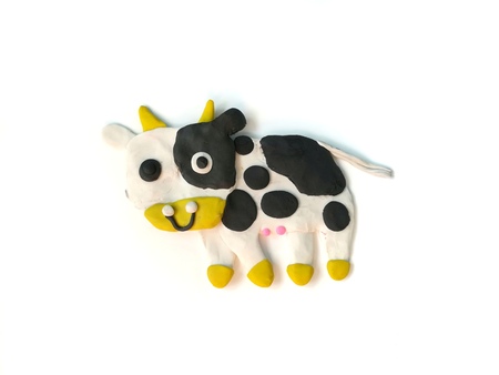 Cute cow made from plasticine clay on white background, colorful animal doughの写真素材