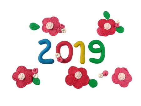 Cute 2019 new year text decorate variety red flowers made from colorful plasticine clay are arrange...