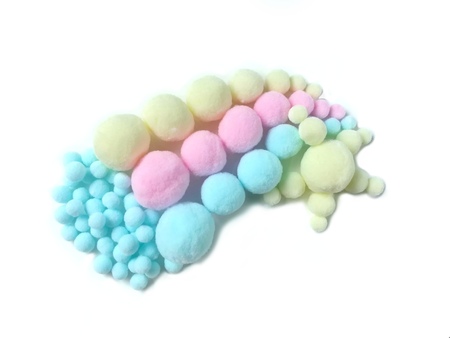 Variety size colorful pom pom made from fiber arrange beautiful rainbow sun and cloud shape on white...