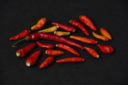 some red chillies on the dark tableの写真素材