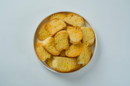flat lay of Stacked dry bread snacks served on a plate isolated on a white background.の写真素材