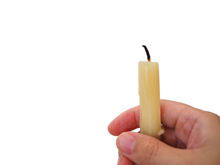 Right lady woman hand holding yellow white small candle, white backgroundの写真素材