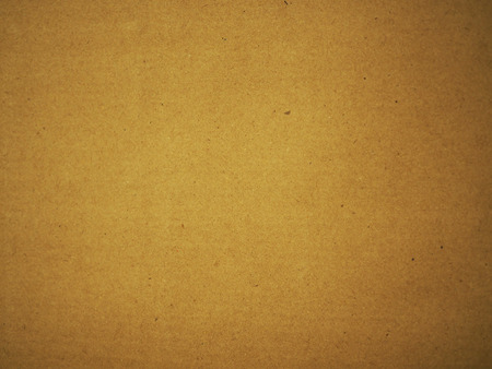 Yellow recycle fiber texture brown kraft paper cover background, center selective focusの写真素材