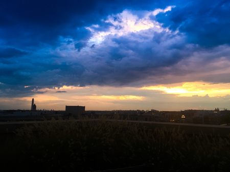 rooftop view of sunset and stormclouds in Washington DCの写真素材