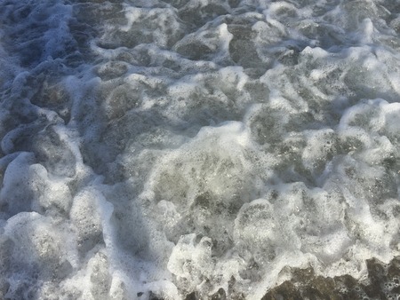 foamy ocean water on the beach