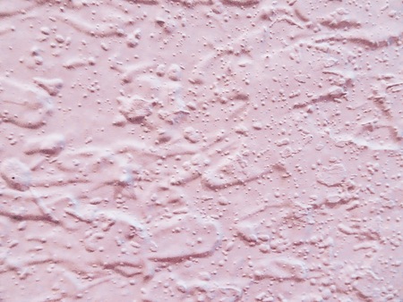 pink speckled wall texture backgroundの写真素材