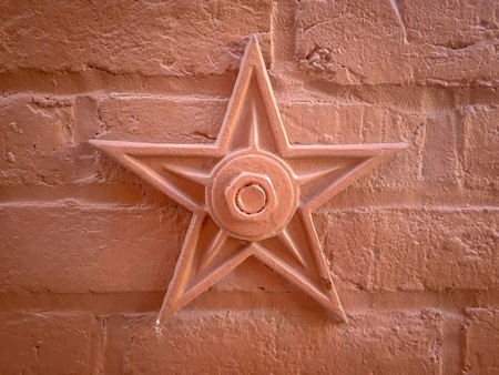 star on red brick wall
