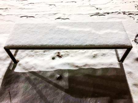 clean white snow on a bench in winter