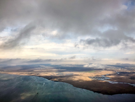 Flying into New Orleans over swamps and the Mississippi River during a storm.の写真素材