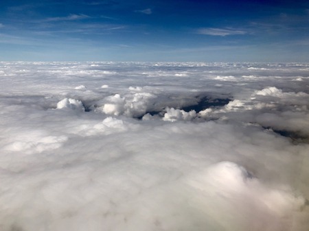 flying over white fluffy clouds and blue sky