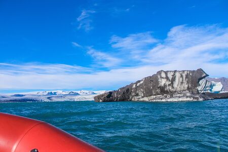 boating through ice in the winter lagoonの写真素材