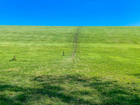 Green hill and blue sky in the countrysideの写真素材