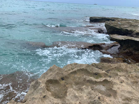 waves splash on the cliffs in summerの写真素材