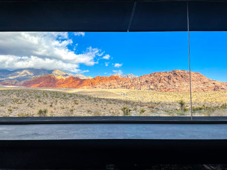 looking out window at rocky red desert mountain in Nevada Red Rocks visitor centerの写真素材