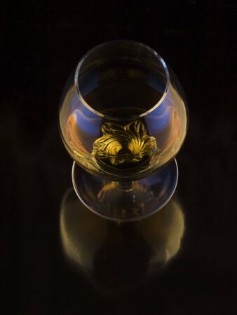 alcoholic beverage in glass and candle  on a dark backgroundの写真素材