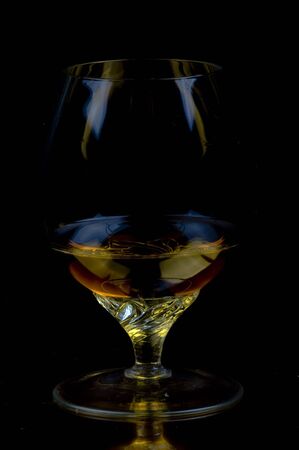 alcoholic beverage in glass on a dark backgroundの写真素材