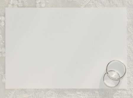 White card for congratulation with rings on a background from laceの写真素材