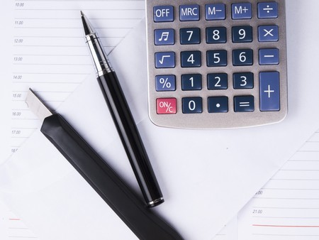 Opened business diary, pen and calculatorの写真素材