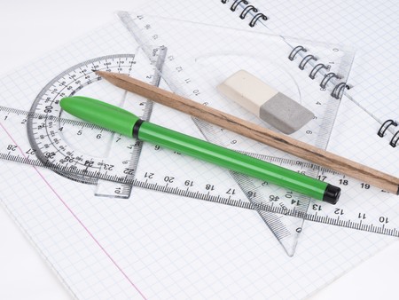 protractor, pen, pencil, rules and workbook page の写真素材