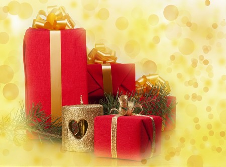 Christmas still life with decorations on  a gold background