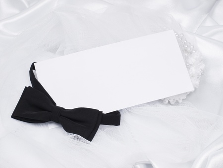 card, bridal  veil and bow  on a background white silkの写真素材