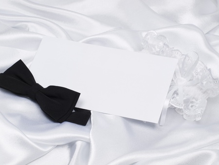 Card, bridal garter and bow  on a background white silkの写真素材
