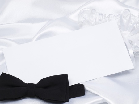 Card, bridal garter and bow  on a background white silkの写真素材