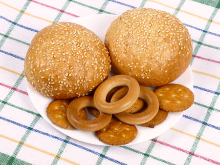 Two rolls, bagels and crackers on a cook-tableの写真素材