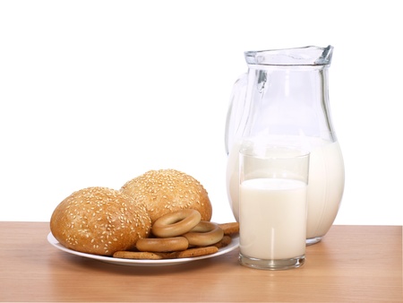 Jug with milk and loaves on by a kitchen table      の写真素材