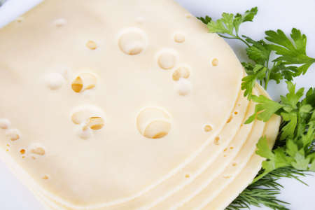 Plate with pieces cheese on a table-clothの写真素材