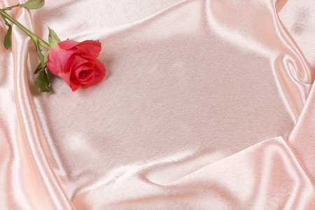 Beautiful rose on a background pink silkの写真素材