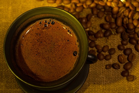 Cup with coffee and been on gray background
