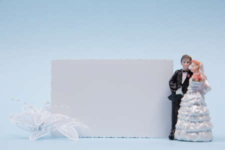 wedding figurines and greeting card  on blue backgroundの写真素材