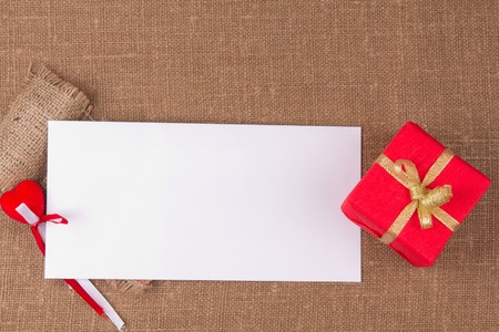 White card for congratulation on a background on coarse fabric