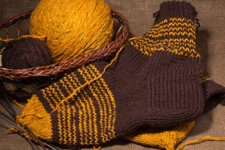 A basket with  knitting yarn and knitting needles