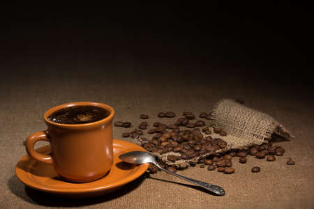 Cup with coffee and been on gray backgroundの写真素材