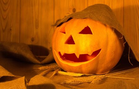 Halloween pumpkin on the table in a rustic barnの写真素材