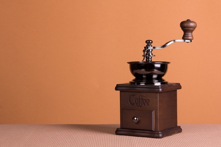 Vintage manual coffee grinder on a brown backgroundの写真素材