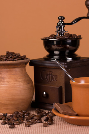 Ceramic cup with a drink and vintage grinderの写真素材