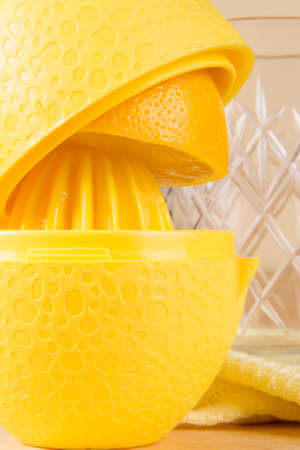 Lemon juicer on the kitchen table and a glass for juice