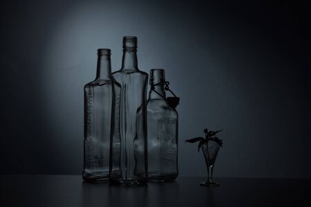 Still-life with three  bottles against a dark backgroundの写真素材