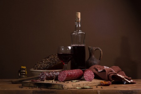 Still life with wine and sausage in vintage styleの写真素材