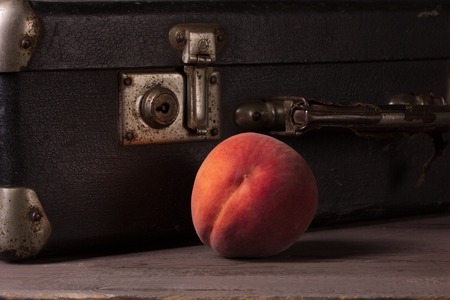 Still life with a package and a fresh peachesの写真素材